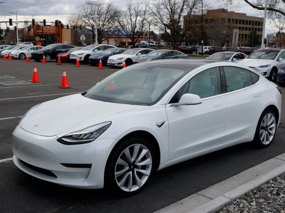 A white Tesla Model 3 electric car.