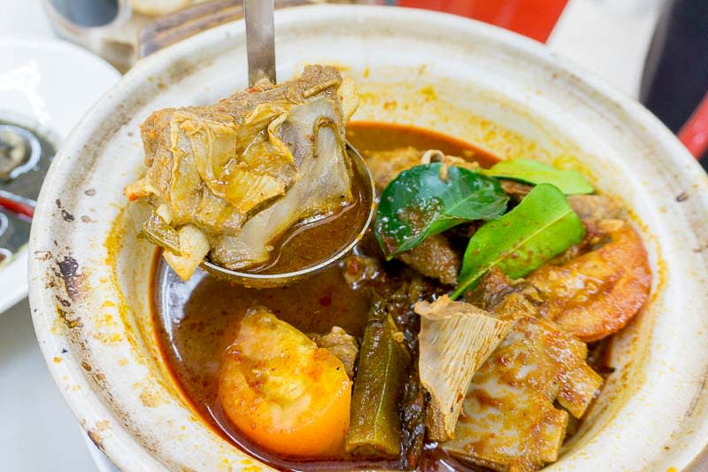 Scooping shot of Asam Pedas Fish Head