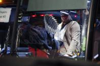 Boston Red Sox's Christian Vazquez, right, holds the 2018 World Series trophy behind Eduardo Nunez as the team arrives back in Boston, Monday, Oct. 29, 2018, after defeating the Los Angeles Dodgers on Sunday in Los Angeles. (AP Photo/Michael Dwyer)