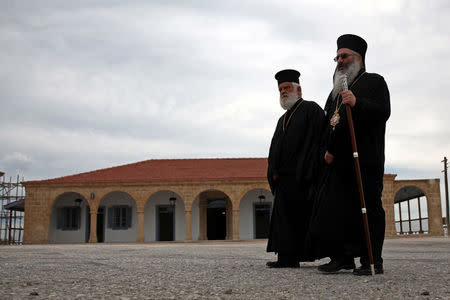 Orthodox priests walk in front of the Monastery of Apostolos Andreas in north-eastern Cyprus after the structure was reopened after two years of renovation, Cyprus November 7, 2016. REUTERS/Yiannis Kourtoglou