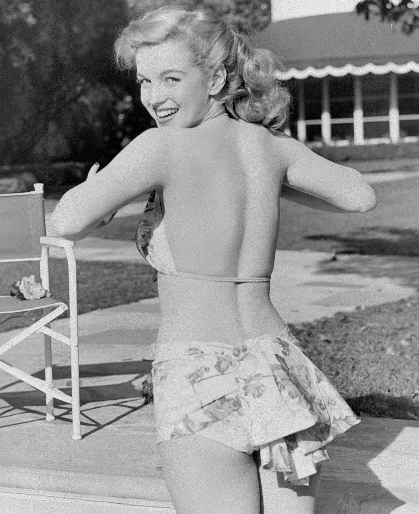 <p>Marilyn began the transformation from all-American charmer to screen siren in this swimsuit shot staged by the studio. </p>