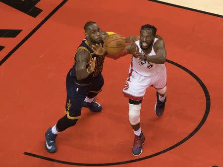 May 21, 2016; Toronto, Ontario, CAN; Cleveland Cavaliers forward LeBron James (23) battles for a ball with Toronto Raptors forward DeMarre Carroll (5) during the third quarter in game three of the Eastern conference finals of the NBA Playoffs at Air Canada Centre. Mandatory Credit: Nick Turchiaro-USA TODAY Sports