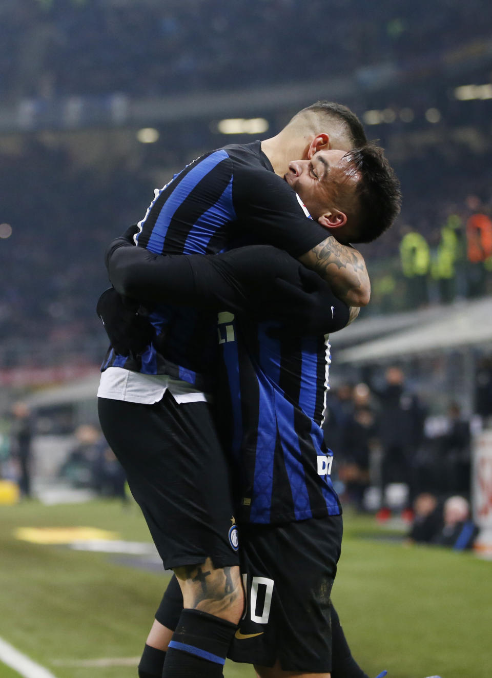 Inter Milan's Mauro Icardi celebrates with teammate Lautaro Martinez after scoring his team's first goal on a penalty kick during an Italian Serie A soccer match between Inter Milan and Udinese, at the San Siro stadium in Milan, Italy, Saturday, Dec. 15, 2018. (AP Photo/Antonio Calanni)