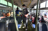 Delhi Transport Corporation (DTC) cleaning staff chemically disinfect a bus as a precautionary measure against the spread of coronavirus.