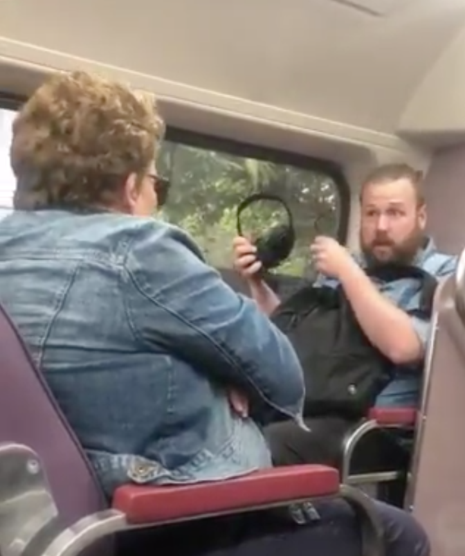 The man pictured removing his glasses and headphones and glaring at the woman accused of coughing. Source: Andy Park