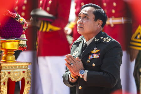 Thailand's Prime Minister Prayuth Chan-ocha pays his respects before a statue of King Chulalongkorn, the grandfather of King Bhumibol Adulyadej, at a military parade at the Chulachomklao Royal Military Academy in Nakornnayok in this September 29, 2014 file photo. REUTERS/Athit Perawongmetha/Files