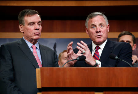 Chairman of the Senate Intelligence Committee Richard Burr (R-NC)(R) and the committee's vice chairman Senator Mark Warner (D-VA) speak to the media about the committee's findings and recommendations on threats to election infrastructure on Capitol Hill in Washington, U.S., March 20, 2018. REUTERS/Joshua Roberts