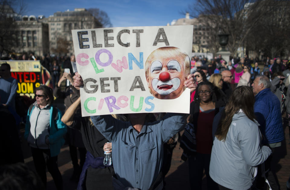 Protesters hold up signs near the White House after the Women's March on Washington.