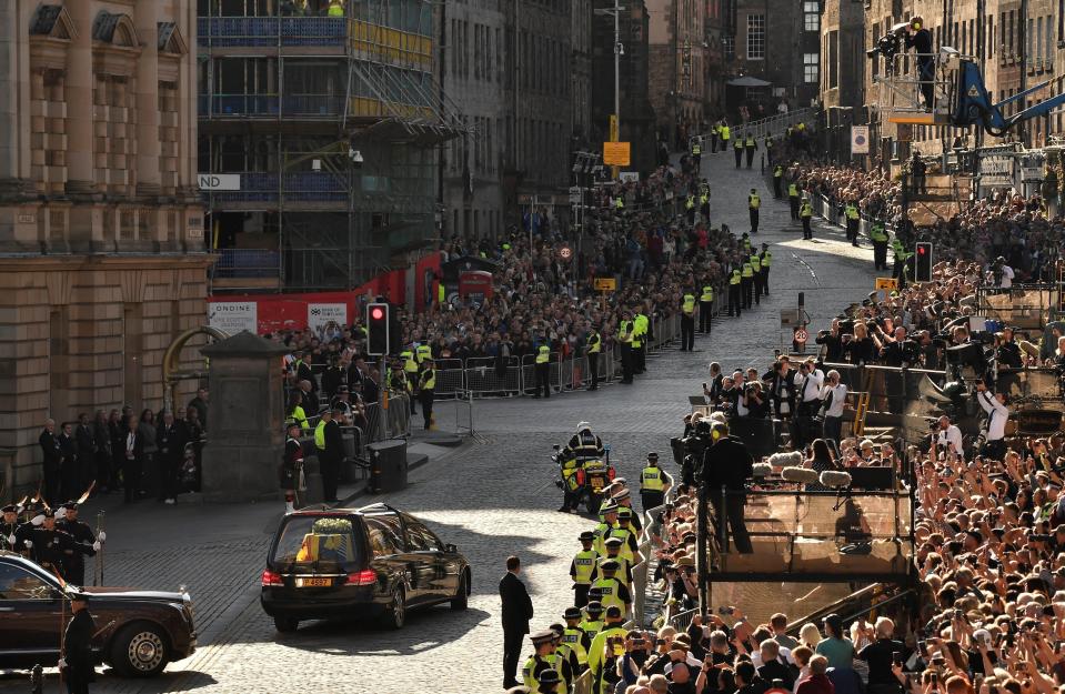 FILE - The media on platforms can be seen covering the hearse carrying the coffin of Queen Elizabeth II as it leaves St. Giles Cathedral, in Edinburgh, Scotland, Tuesday, Sept. 13, 2022. Plans by news organizations that have been in place for years — even decades — to cover the death of Queen Elizabeth II were triggered and tested when the event took place. London has been inundated with journalists, with more headed to the city for the funeral services on Monday. (Louisa Gouliamaki/Pool Photo via AP, File)