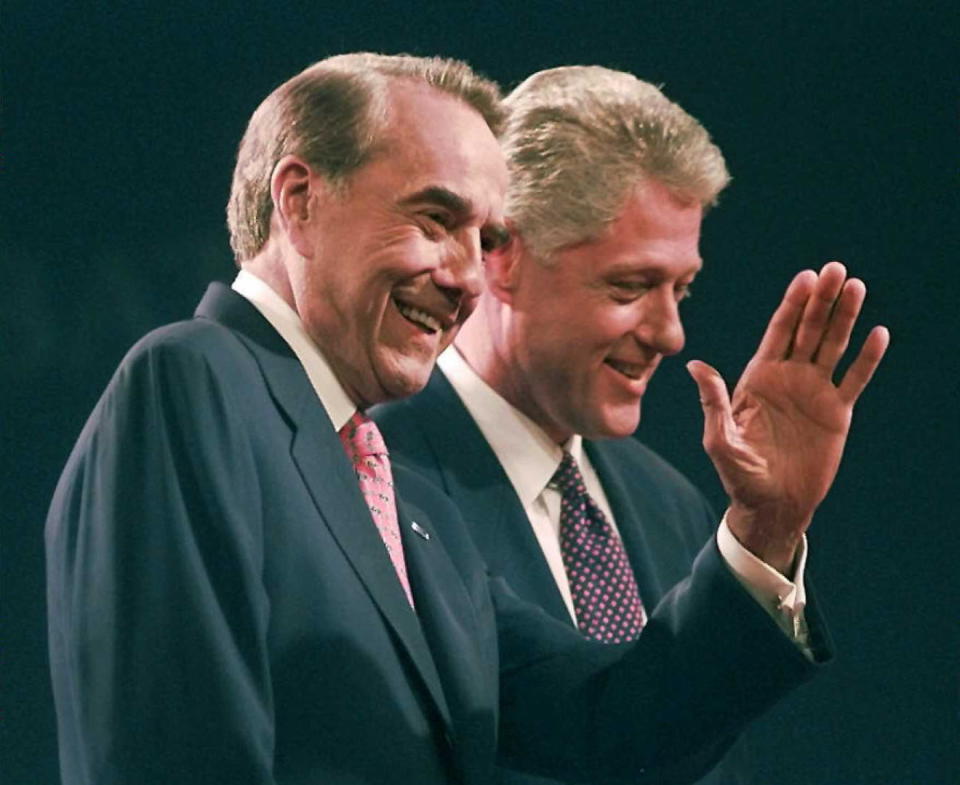 Republican challenger Bob Dole waves to the crowd along side of President Bill Clinton at the conclusion of their first debate in Hartford, Conn. in 1996<span class="copyright">Jon Levy—AFP/Getty Images</span>