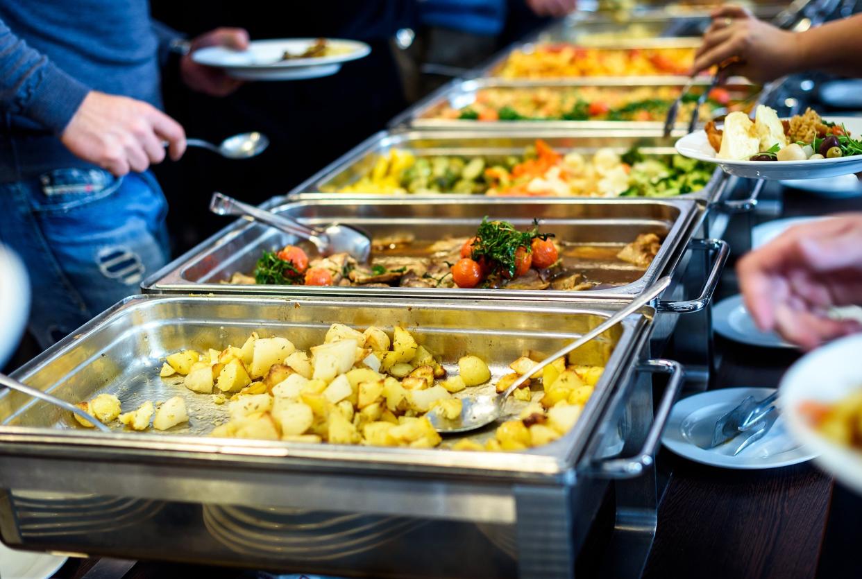 group of people in all you can eat catering buffet food