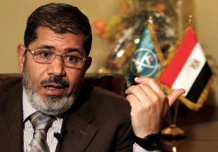 FILE PHOTO - Mohamed Mursi, head of the Brotherhood's newly formed Justice and Freedom Party gestures during an interview with Reuters in Cairo