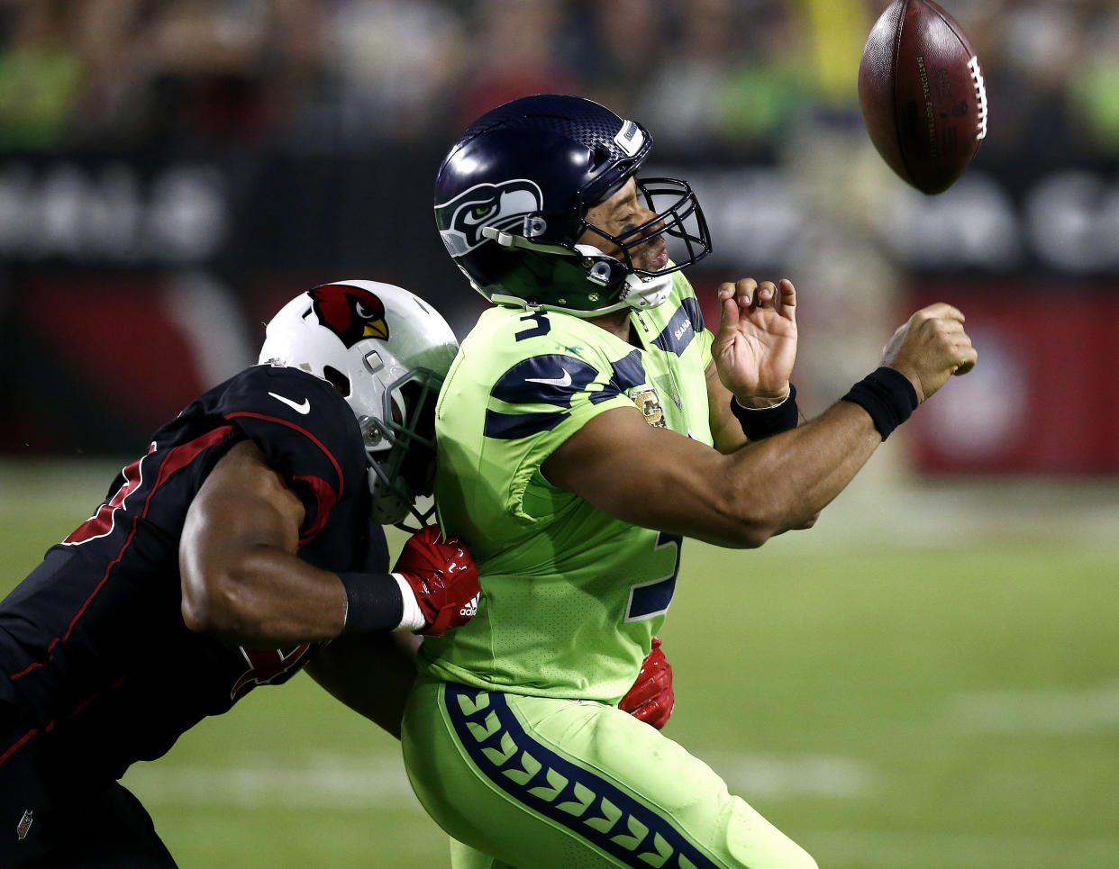 Seattle Seahawks quarterback Russell Wilson (3) loses the ball out of bounds as he is hit by Arizona Cardinals inside linebacker Haason Reddick (43) during the second half of an NFL football game, Thursday, Nov. 9, 2017, in Glendale, Ariz. (AP Photo/Ross D. Franklin)