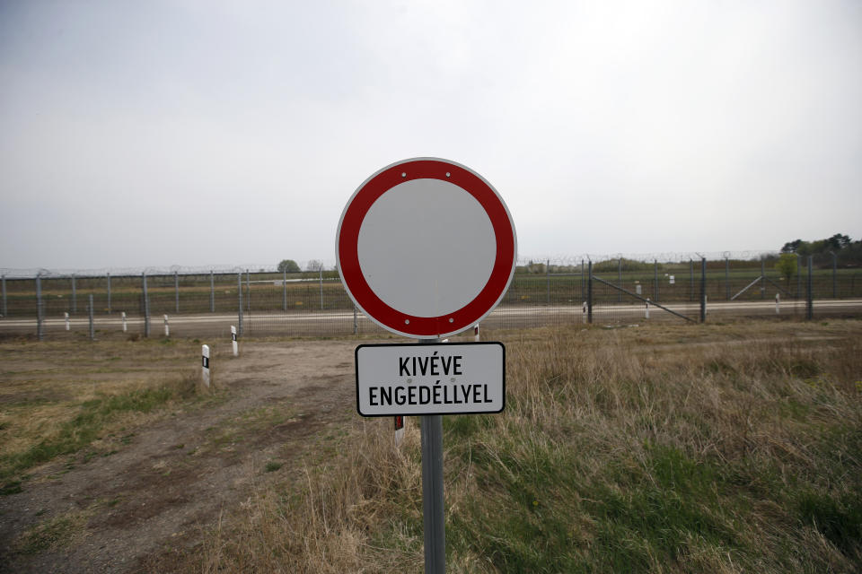 In this photo taken Monday, April 8, 2019, a road traffic warning sign reads: Except with a permit", at Hungary's border with Serbia near the village Asotthalom, Hungary. With a campaign centered on stopping immigration, Hungary’s ruling Fidesz party is expected to continue its dominance in the European Parliament election at the end of May. While Hungary has been practically closed to immigrants from the Middle East, Asia and Africa since Prime Minister Viktor Orban had border fences built in 2015, he continues to warn voters about the threat of a “migrant invasion” that would put at risk Europe’s Christian culture. (AP Photo/Darko Vojinovic)