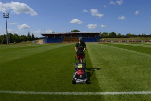 A worker mows the lawn of the training ground at the Spain's football team base camp in the hotel Mistral Sports in Gniewino on June 15 during the Euro 2012 football championships. Spain threw open the doors of their secluded hideaway in northern Poland to offer fans a tantalising glimpse of just how European and world champions live