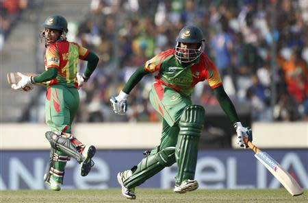 Bangladesh's captain Mushfiqur Rahim (L) and Shakib Al Hasan run between the wickets against Australia during their ICC Twenty20 World Cup match at the Sher-e-Bangla National Cricket Stadium in Dhaka April 1, 2014. REUTERS/Andrew Biraj