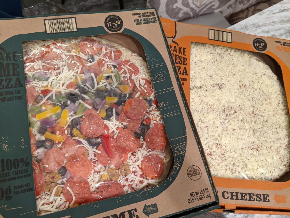 two Mama Cozzi's pizza in their original cardboard boxes