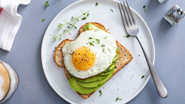 Egg and avocado toast on plate 