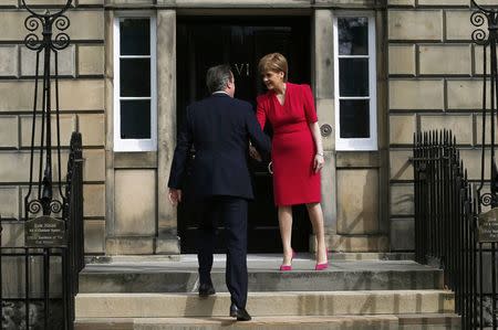 Scotland's First Minister Nicola Sturgeon (R), greets Britain's Prime Minister David Cameron, as he arrives for their meeting in Edinburgh, Scotland, Britain May 15, 2015. REUTERS/Russell Cheyne