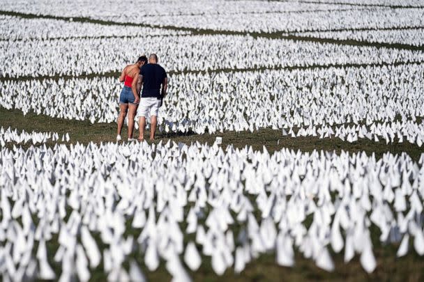 PHOTO: FILE - People visit the 'In America: Remember' public art installation near the Washington Monument on the National Mall, Sept. 18, 2021 in Washington, DC. (Kent Nishimura/Los Angeles Times via Getty Images, FILE)