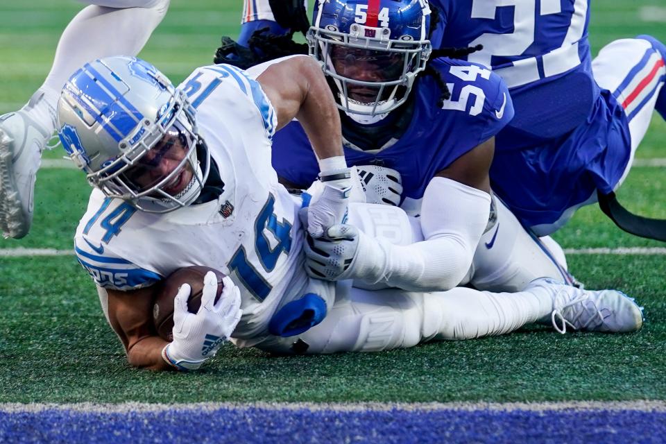 Detroit Lions wide receiver Amon-Ra St. Brown (14) is tackled by New York Giants linebacker Jaylon Smith (54) during the second half Nov. 20, 2022, in East Rutherford, N.J.