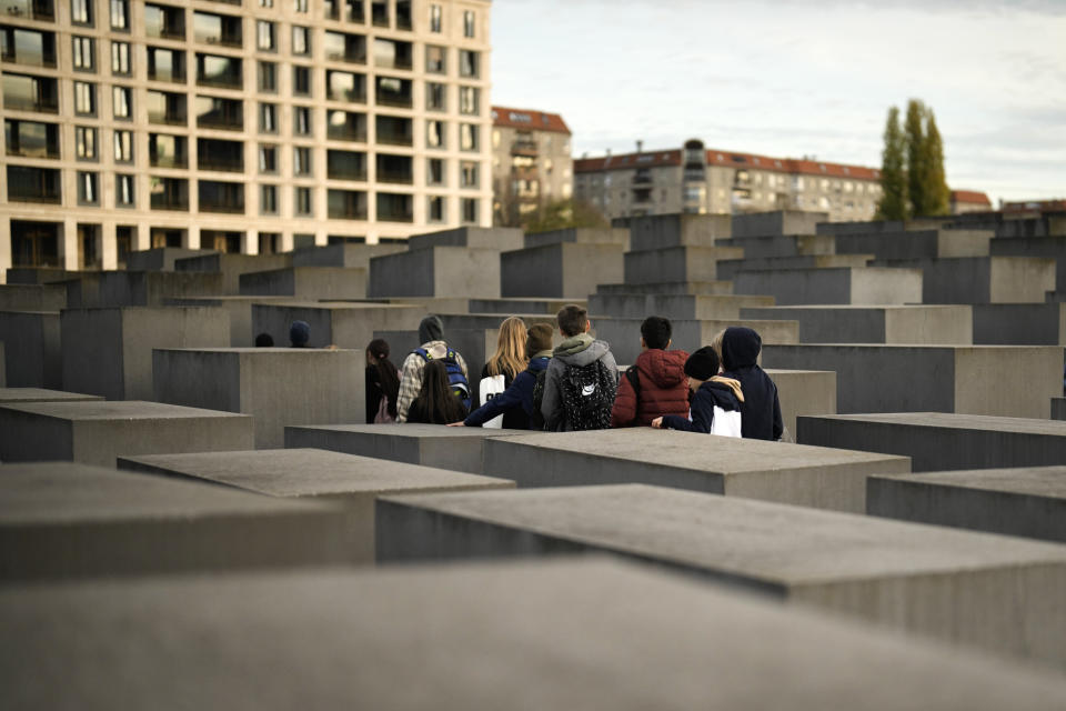Students visit the Holocaust Memorial in Berlin, Germany, Tuesday, Nov. 8, 2022. Holocaust survivors from around the world are warning about the reemergence of antisemitism as they commemorated Wednesday, Nov. 9, 2022, the 84th anniversary of the Kristallnacht or the "Night of Broken Glass", when Nazis terrorized Jews throughout Germany and Austria. (AP Photo/Markus Schreiber)