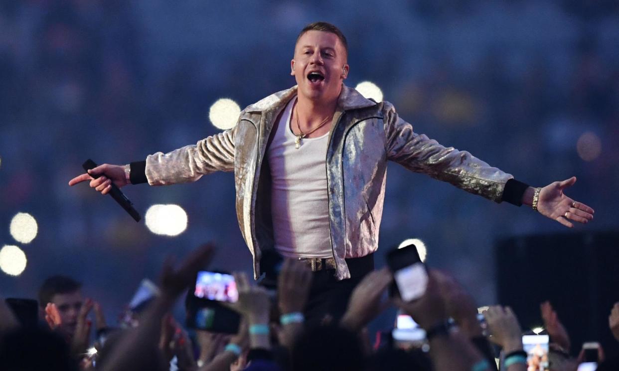 <span>Macklemore gestures to the crowd as he performs on stage in Australia. The rapper performed his pro-Palestine track Hind’s Hall in New Zealand for the first time.</span><span>Photograph: David Moir/AAP</span>