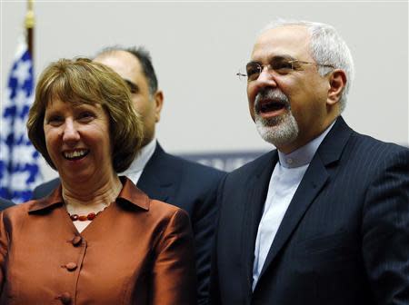 European Union foreign policy chief Catherine Ashton (L) smiles next to Iranian Foreign Minister Mohammad Javad Zarif during a ceremony at the United Nations in Geneva November 24, 2013. REUTERS/Denis Balibouse