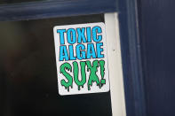 <p>A sticker is shown in a window near where algae is fouling the St. Lucie River in Stuart, Fla., July 11, 2016. (Photo: Joe Raedle/Getty Images) </p>