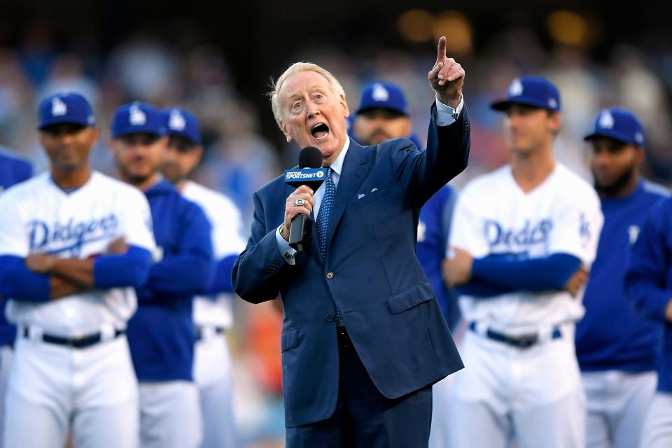 FILE - In this May 3, 2017, file photo, Los Angeles Dodgers broadcaster Vin Scully speaks during his induction into the team's Ring of Honor prior to a baseball game between the Dodgers and the San Francisco Giants, in Los Angeles. Retired Baseball Hall of Fame broadcaster Scully turned 93 on Sunday, Nov. 29, 2020, and marked the day by watching football. (AP Photo/Mark J. Terrill, File)