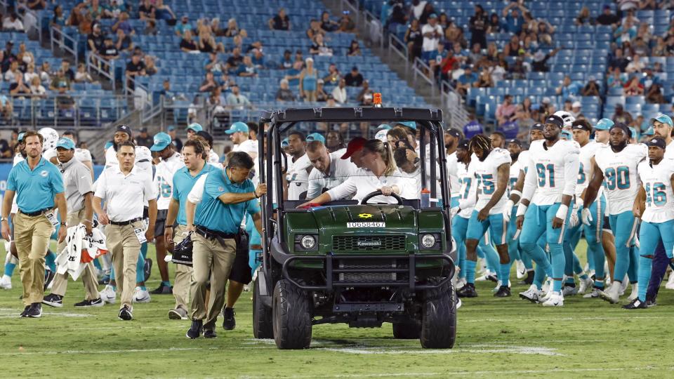 Miami Dolphins wide receiver Daewood Davis (87) is carted off the field during the team's NFL preseason football game against the Jacksonville Jaguars, Saturday, Aug. 26, 2023, in Jacksonville, Fla. (Al Diaz/Miami Herald via AP)