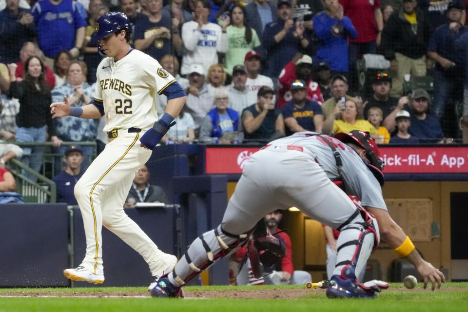 Milwaukee Brewers' Christian Yelich scores past St. Louis Cardinals catcher Iván Herrera during the fourth inning of a baseball game Friday, May 10, 2024, in Milwaukee. Yelich scored on a hit by Rhys Hoskins. (AP Photo/Morry Gash)