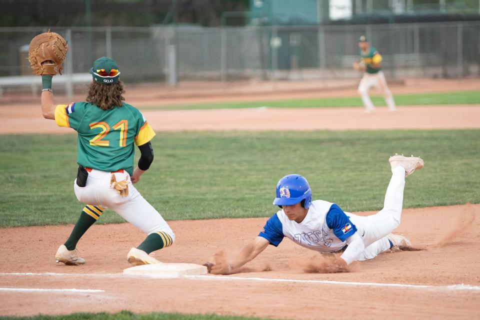 Pueblo Azteca's Jake Olguin-Pacheco slides safely back to first base during a game against Greeley GoJo on the first day of the 42nd annual Andenucio Memorial Baseball Tournament on Thursday, June 16, 2022.