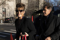 Former Alaska Governor Sarah Palin arrives at federal court with former NHL hockey player Ron Duguay in New York on Friday, Feb. 11, 2022. Palin claims the New York Times damaged her reputation with an editorial linking her campaign rhetoric to a mass shooting. (AP Photo/Jeenah Moon)