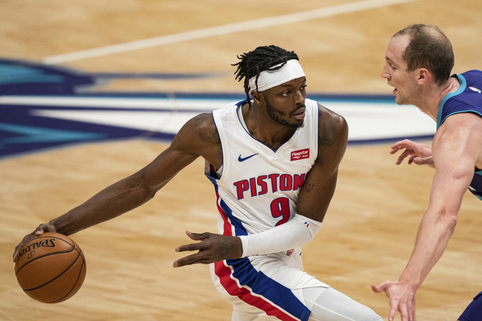 Detroit Pistons forward Jerami Grant (9) is guarded by Charlotte Hornets center Cody Zeller during the first half of an NBA basketball game in Charlotte, N.C., Thursday, March 11, 2021. (AP Photo/Jacob Kupferman)