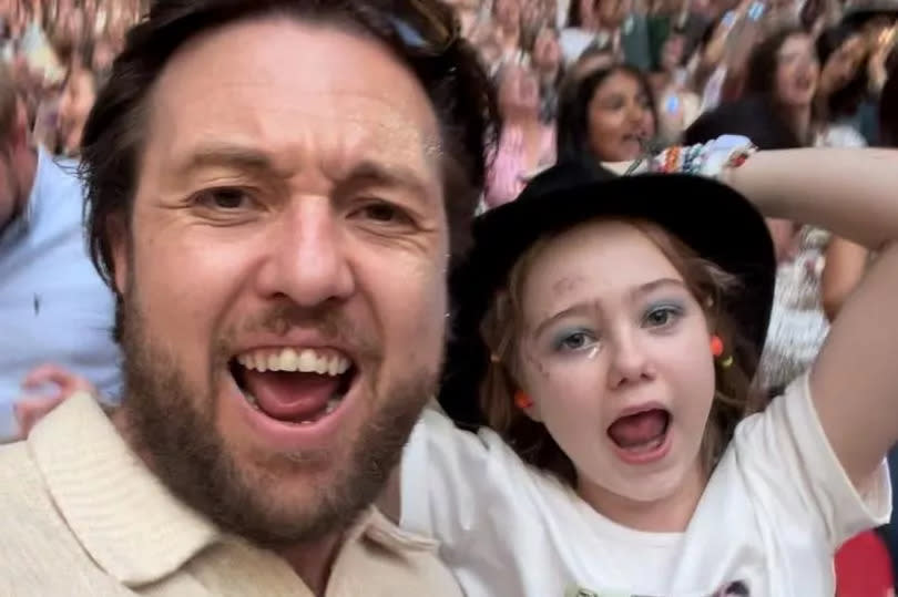 Nik Oliver and Elsie Oliver dancing at Wembley during Taylor Swifts Eras Tour