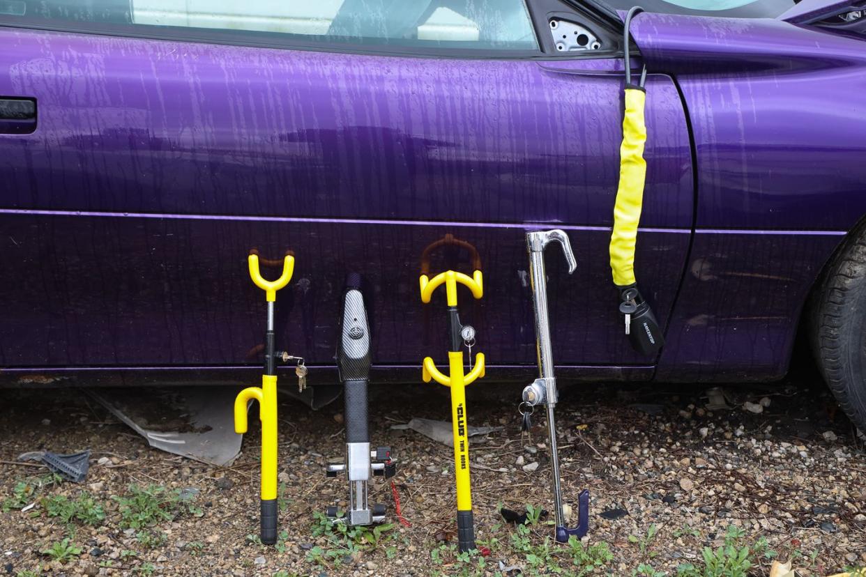 a train is parked next to some yellow poles