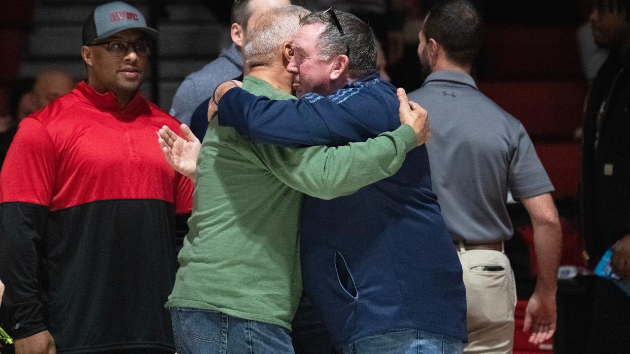 Eamonn Cullen, father of New Jersey State Police Trooper Sean Cullen, center right, hugs Bryan Freeman, father of Sgt. Bryan Freeman, Jr., during a ceremony held prior to the 7th Annual Wrestling for Heroes Match held at Rancocas Valley High School on Wednesday, January 24, 2024.
