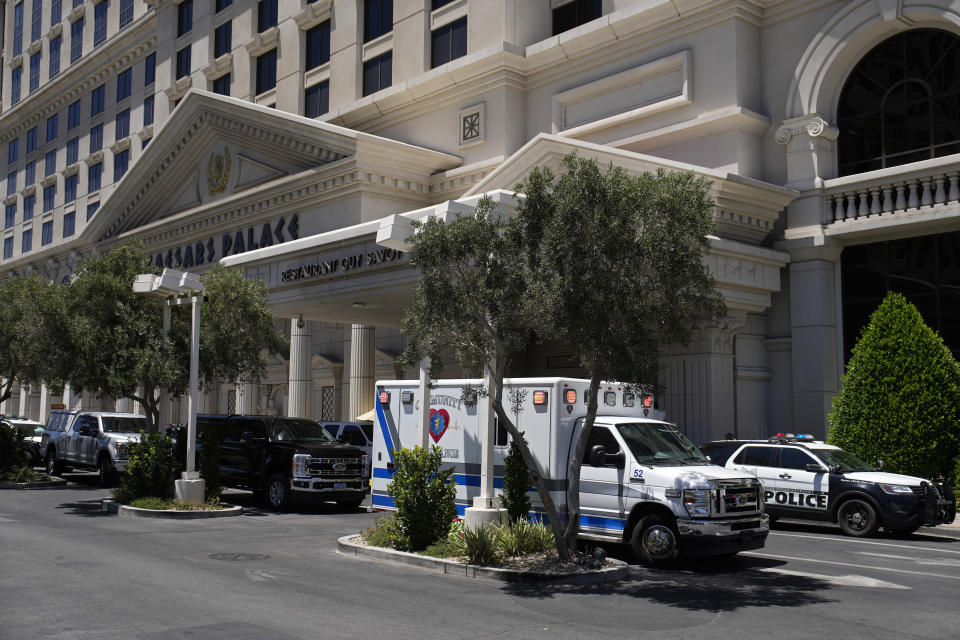 Police and emergency vehicles are staged at Caesars Palace hotel-casino Tuesday, July 11, 2023, in Las Vegas. A man has taken a woman hostage inside the Caesars Palace Hotel & Casino, Las Vegas police said Tuesday. (AP Photo/John Locher)