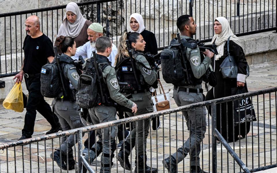 Israeli border guards patrol outside the Damascus Gate to the old city of Jerusalem