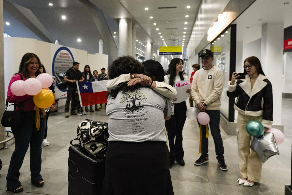 María Hastings, who lives in Tampa, FL, embraces for first time her biological mother upon her arrival to the airport in Santiago, Chile, Sunday, Feb. 18, 2024. Hasting's trip was organized by Connecting Roots, an organization that helps reunite with their Chilean biological families children who were taken to be put up for adoption during the dictatorship of Gen. Augusto Pinochet. (AP Photo/Esteban Felix)