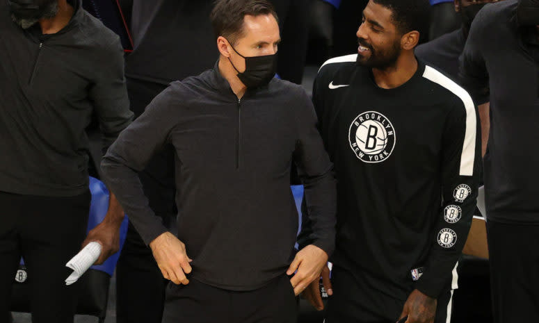 Brooklyn Nets head coach Steve Nash looks on with Kyrie Irving during a preseason game