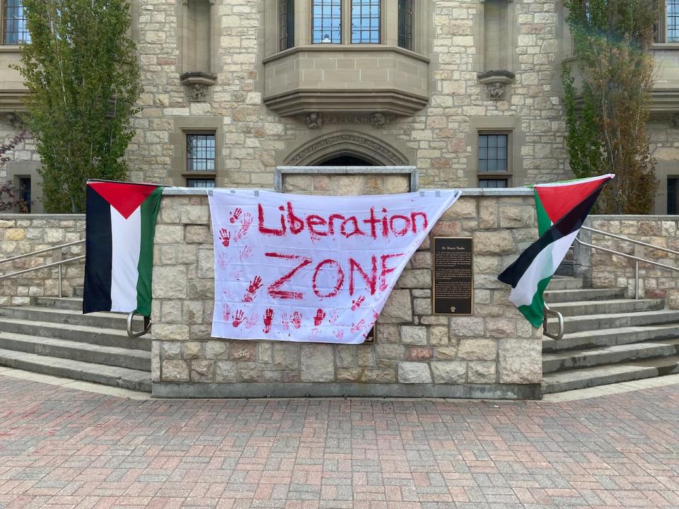 Students put up Palestinian flags at the entrance of the University of Saskatchewan administration building during a sit-in on campus on May 17, 2024.