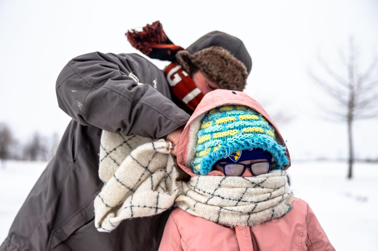 Gretchen Zosel’s glasses freeze over as she gets bundled up by her stepfather, Eric Henderson, in this 2021 file photo.