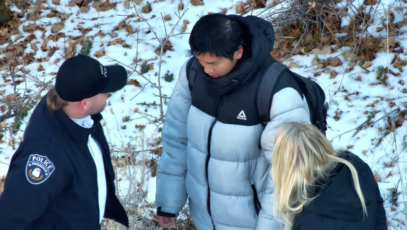 Law enforcement officials talk with Kai Zhuang, a 17-year-old Chinese exchange student, after he was found safe in a tent near Brigham City on Sunday, Dec. 31, 2023.