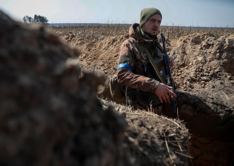 A Ukrainian service member is seen at a position on the front line in the north Kyiv region