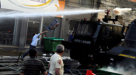 Protestors fight with the police during a demonstration against a possible change in the law to allow for presidential re-election in front of the Congress building in Asuncion, Paraguay, March 31, 2017. REUTERS/Jorge Adorno