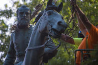 The monument of Stonewall Jackson is prepared to be lifted from its pedestal on Saturday, July 10, 2021 in Charlottesville, Va. The removal of the Lee and Jackson statues comes nearly four years after violence erupted at the infamous “Unite the Right” rally. (AP Photo/John C Clark)