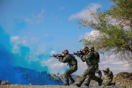 Soldiers of the Chinese People's Liberation Army (PLA) take part in a combat training in the Gobi desert in Jiuquan, Gansu province, China May 18. REUTERS/Stringer