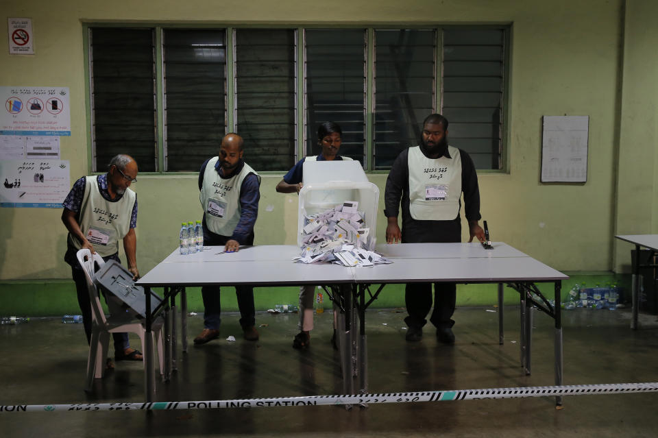 Maldivian polling workers open a ballot box to count votes at the end of the presidential election day in Male, Maldives, Sunday, Sept. 23, 2018. As officials began tabulating votes after the polls closed at 7 p.m., people in the Maldives and observers outside the tiny, tropical South Asian country waited for the results to see whether the opposition's cries of a rigged vote would be validated. (AP Photo/Eranga Jayawardena)